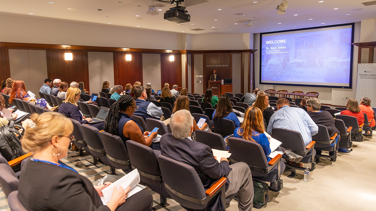 A crowd watches a slideshow presentation at the 2023 event