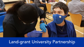 Land-grant university partnership with picture of nurse giving a shot