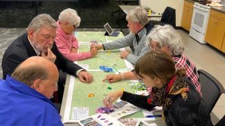 People conduct a housing study around a table