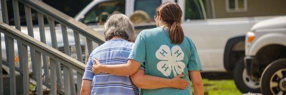 A 4-H member walks with an older person