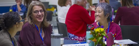 Participants talk at tables at the Engagement Academy