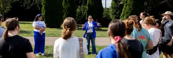 A person speaks to a group at The Arboretum