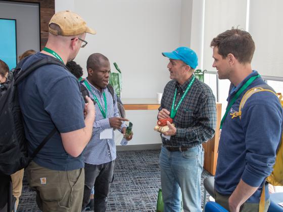 Four men discuss corn varieties at a local food summit